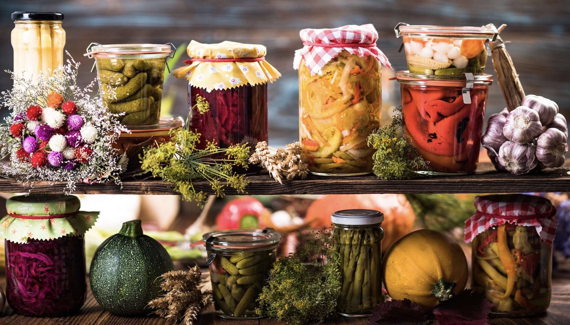 Assortment of different jars of preserved food on a shelf.