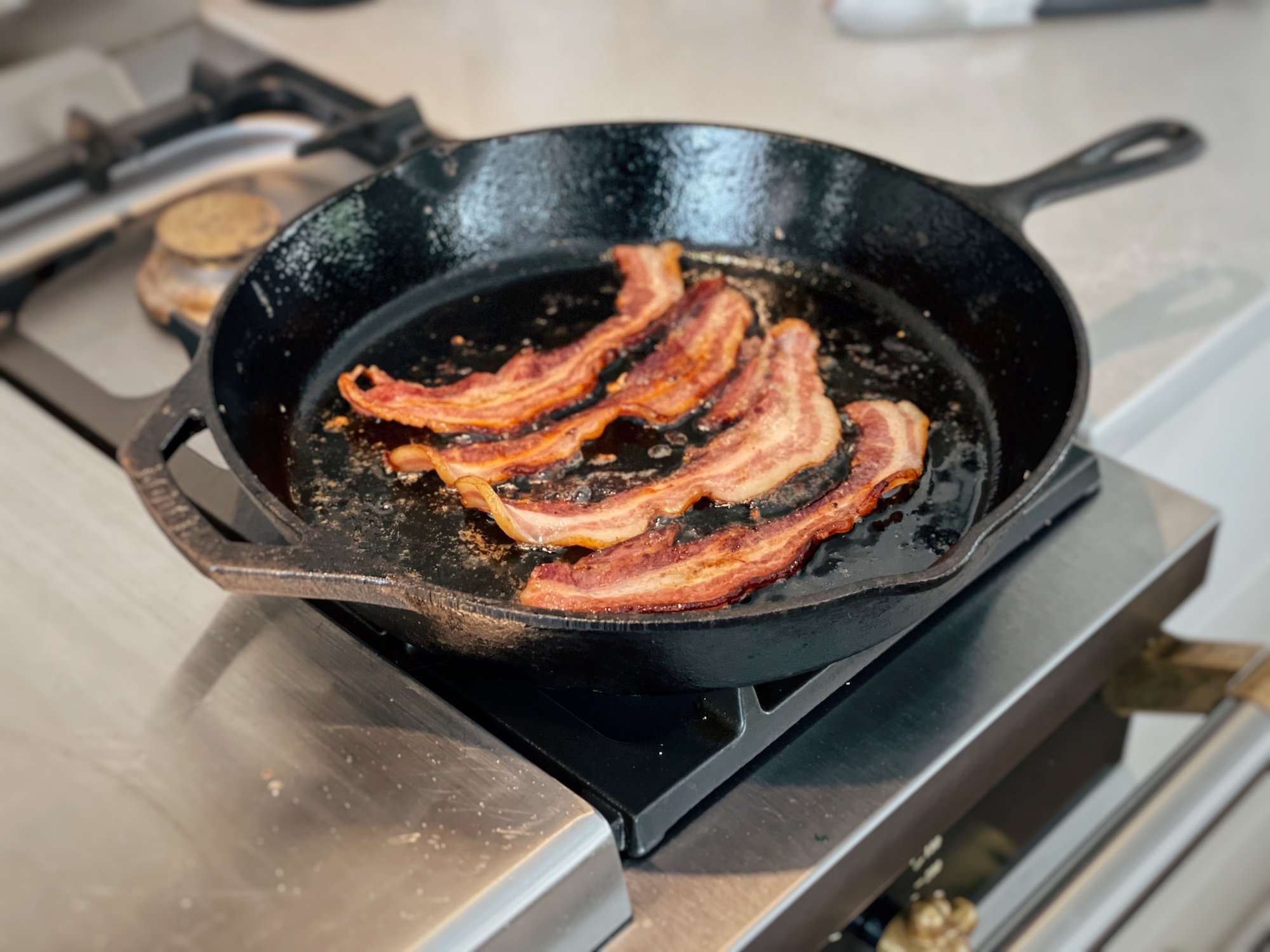 4 strips of bacon in a a cast iron pan