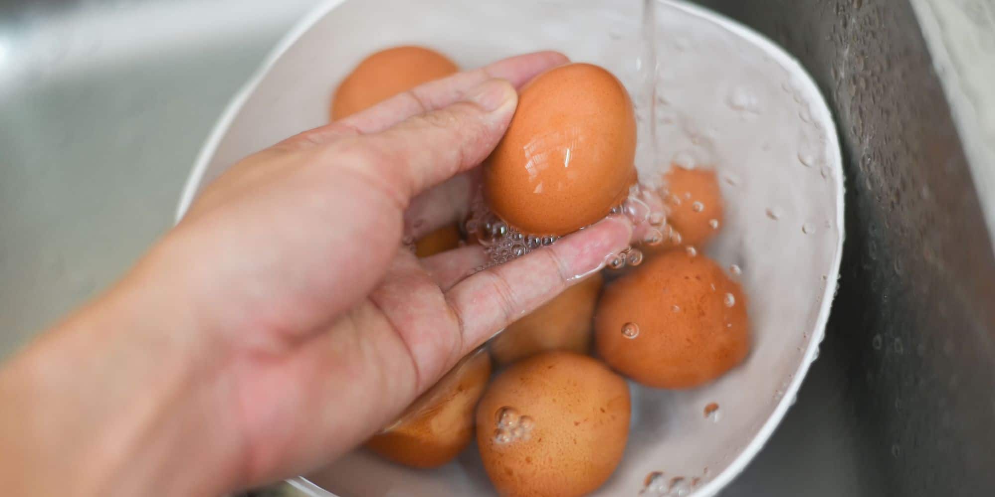 Washing eggs in a bowl of water