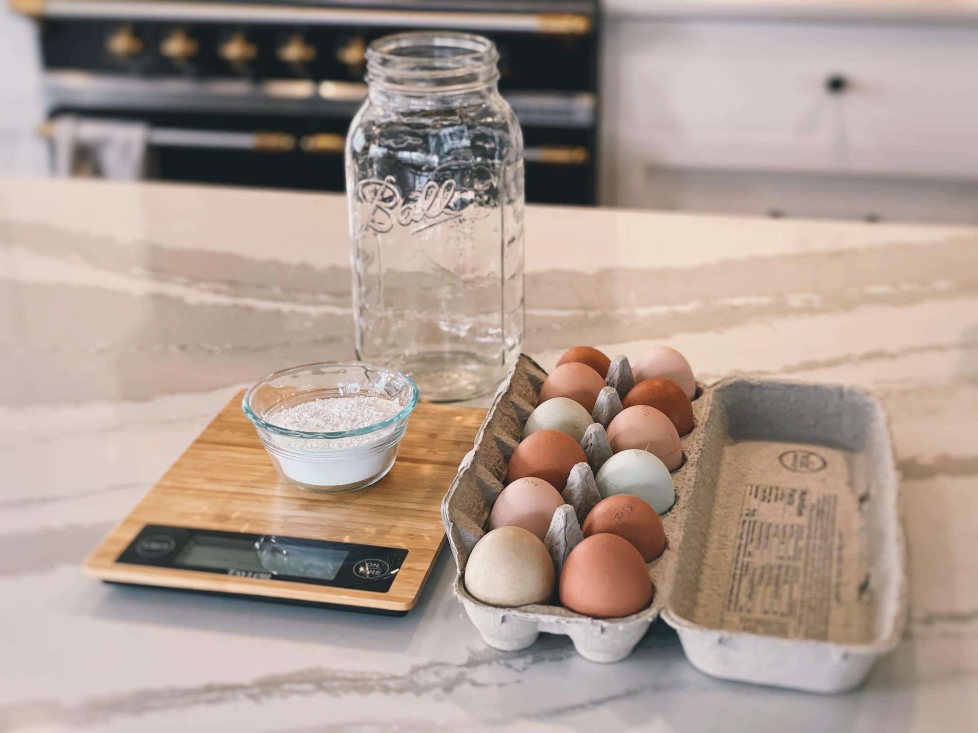 Supplies laid out on a kitchen counter for water glassing eggs