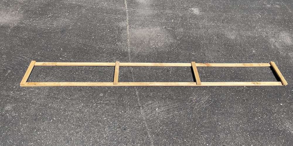 The frame for the no-dig skirt laying on a driveway