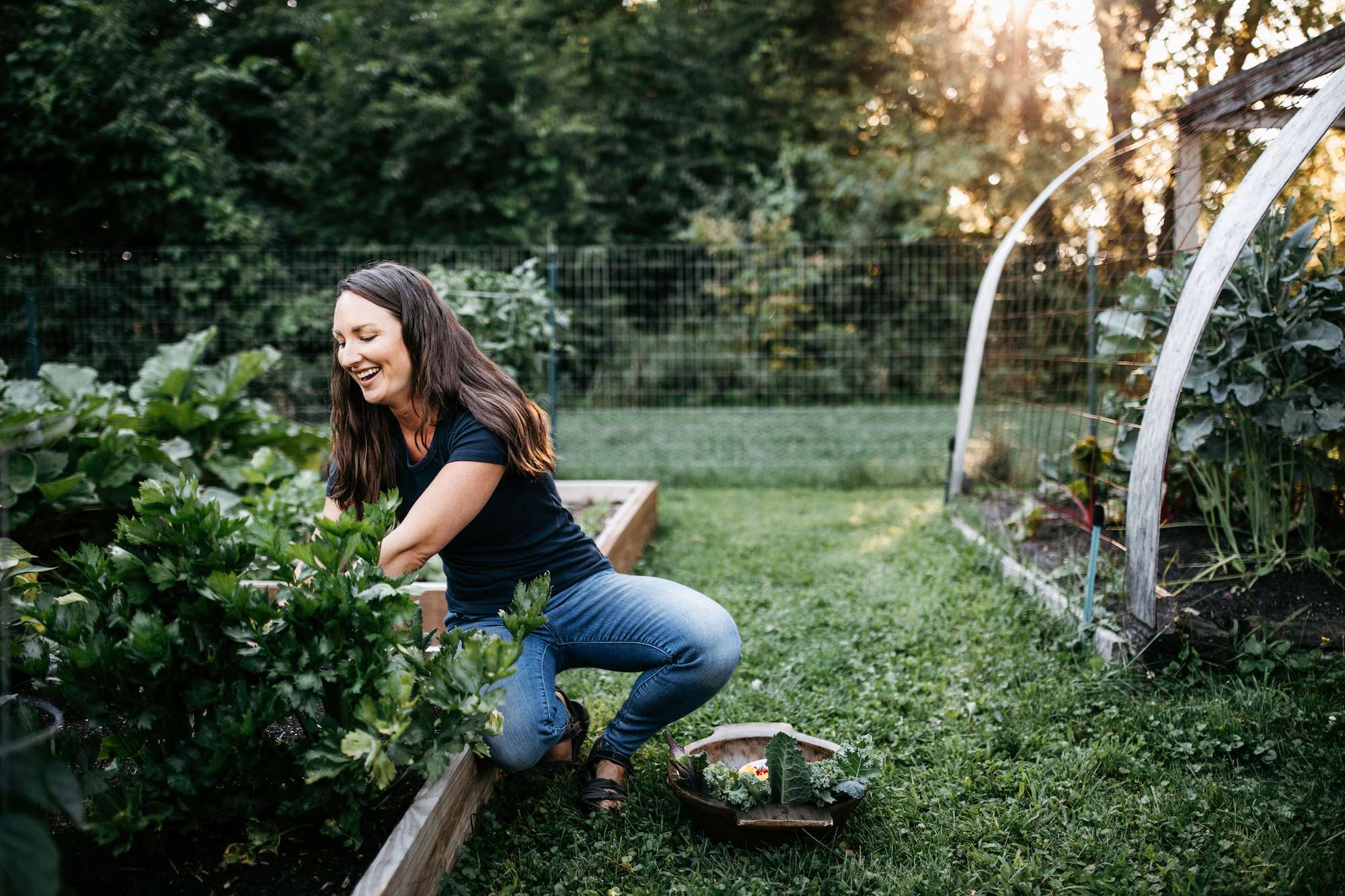 A photo of Katie picking vegetables in her garden