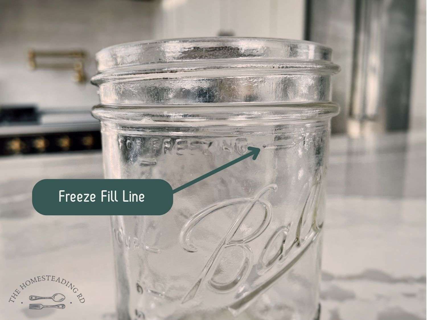 A close up view of the freeze fill line on a wide mouth mason jar