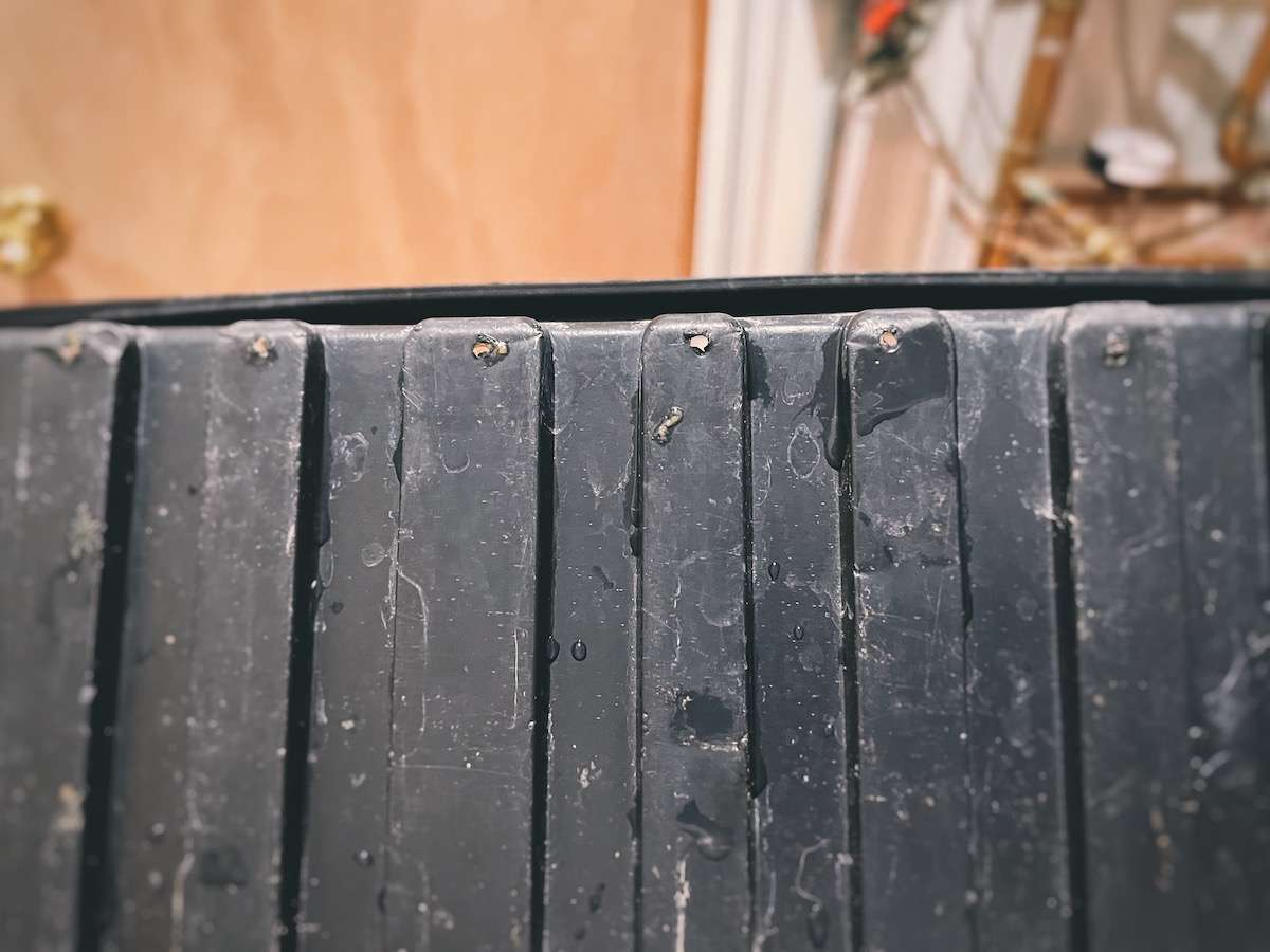 A close-up view of the holes drilled in a fodder tray