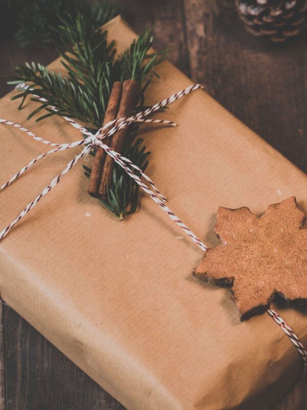 A simply wrapped gift with brown paper and twine.