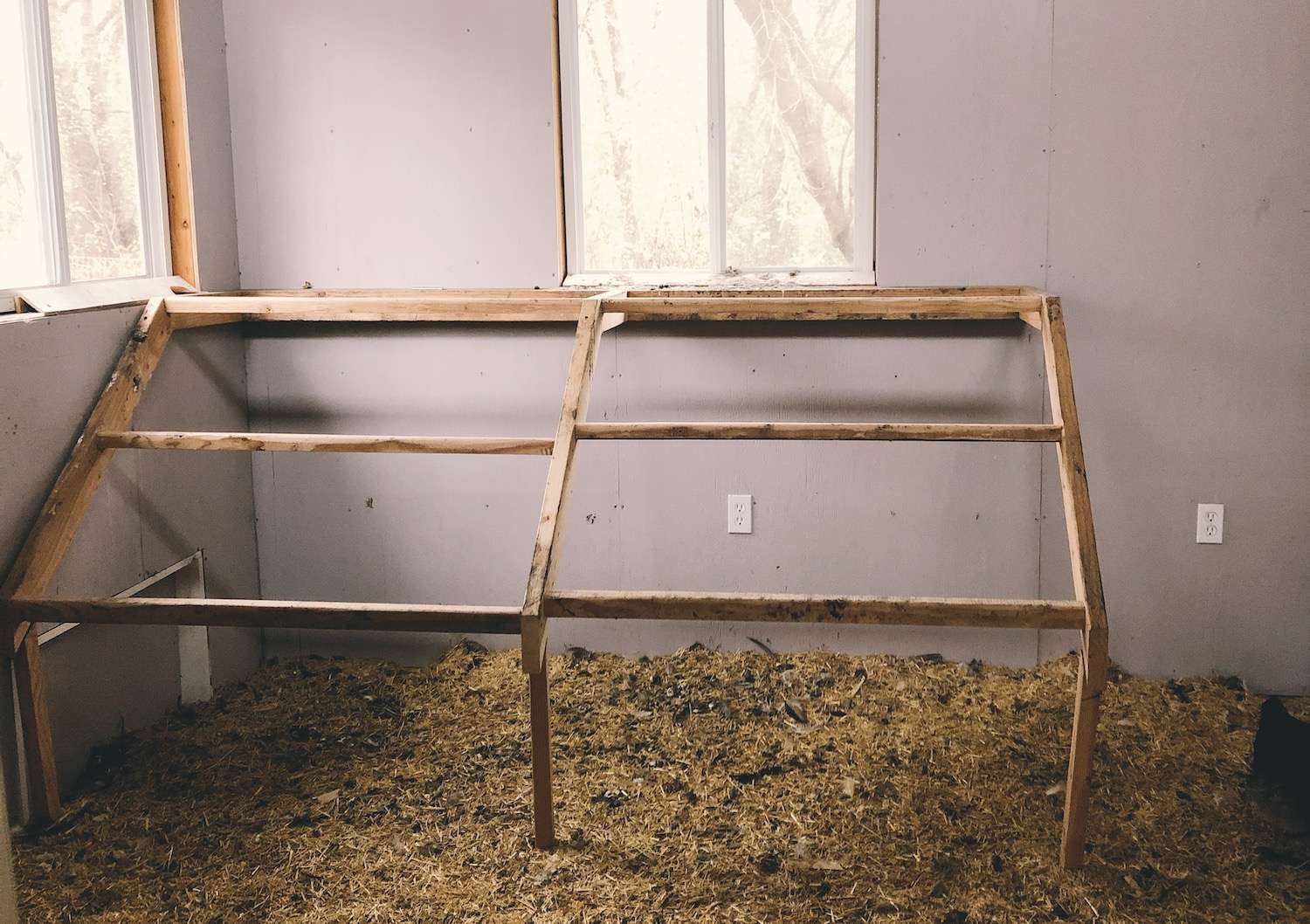 A photo of a set of roosting bars inside a chicken coop