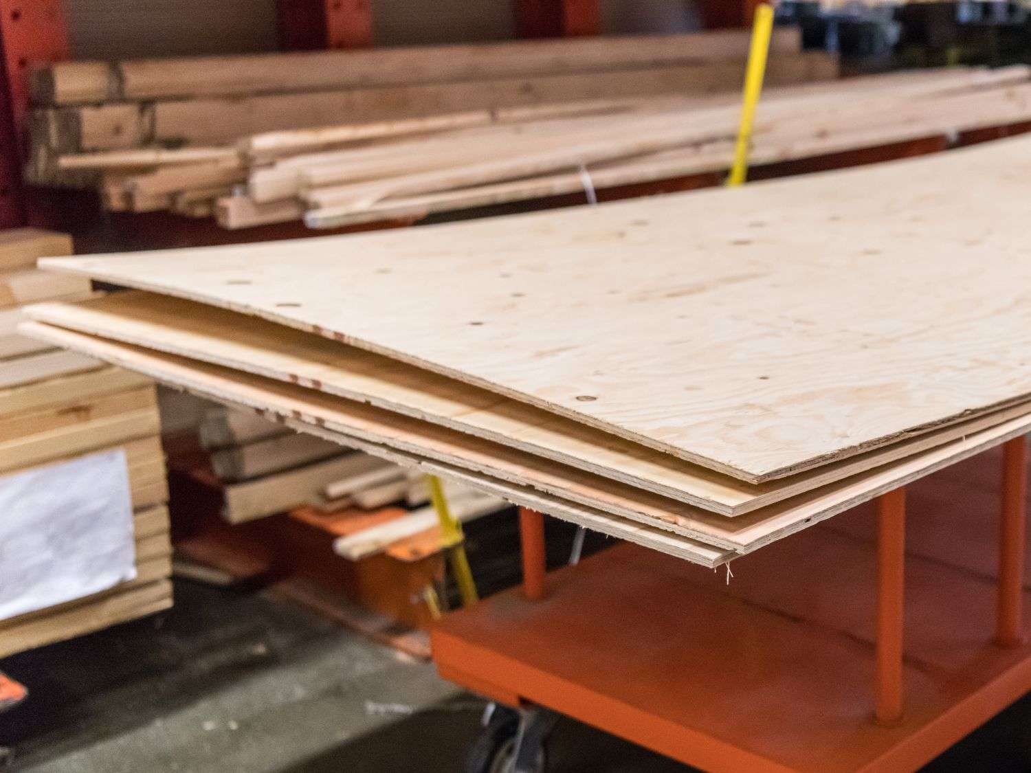 A cart full of plywood at a hardware store