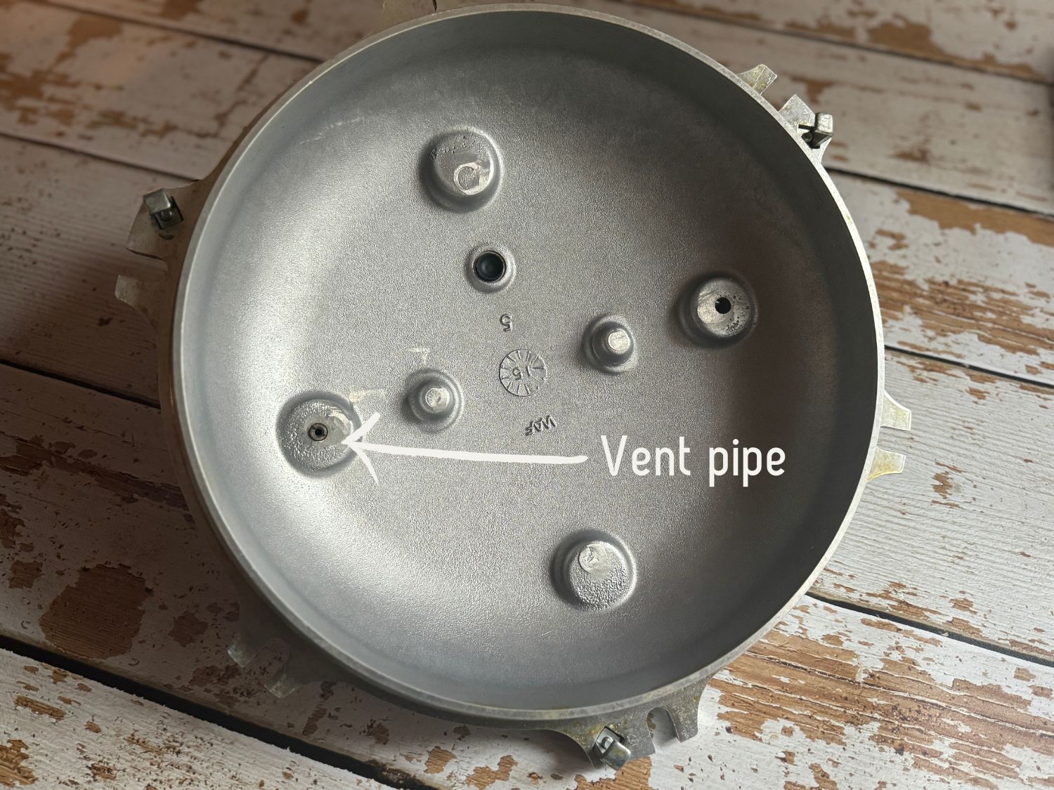 A photo pointing out where the vent pipe is on the pressure canner cover