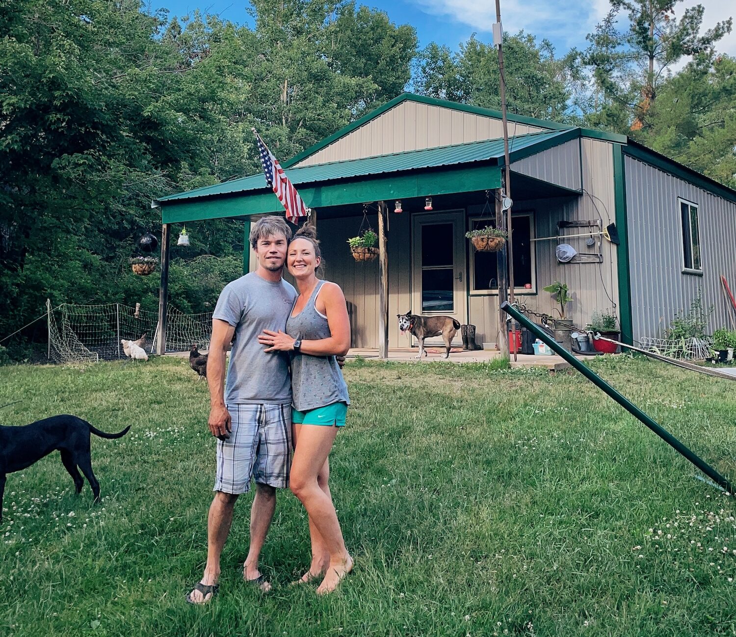 A phot of Ryan and I in front of our cabin on our homestead
