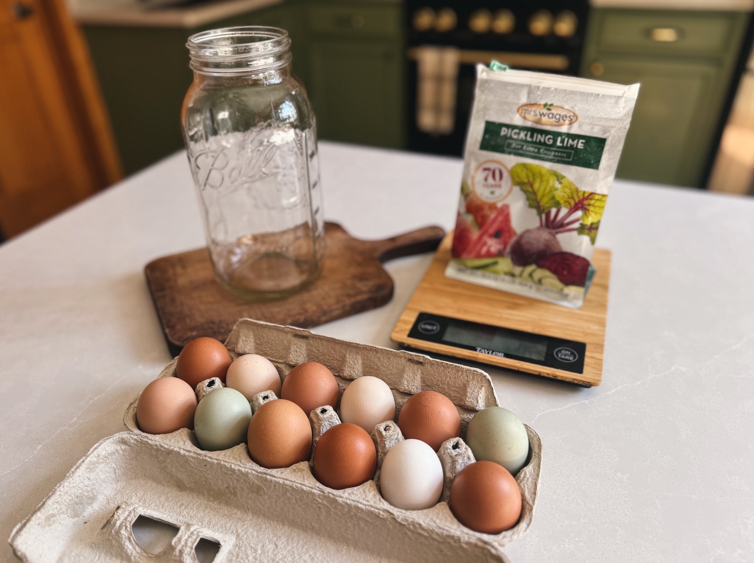 All of the supplies needed to water glass eggs are laid out on a kitchen island