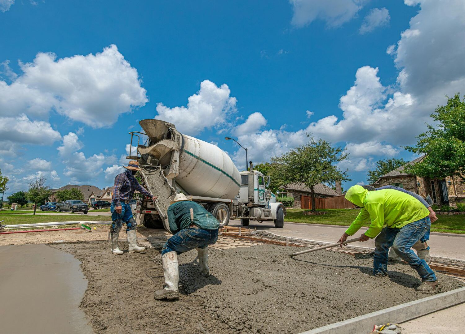 A crew of construction workers laying a concrete foundation