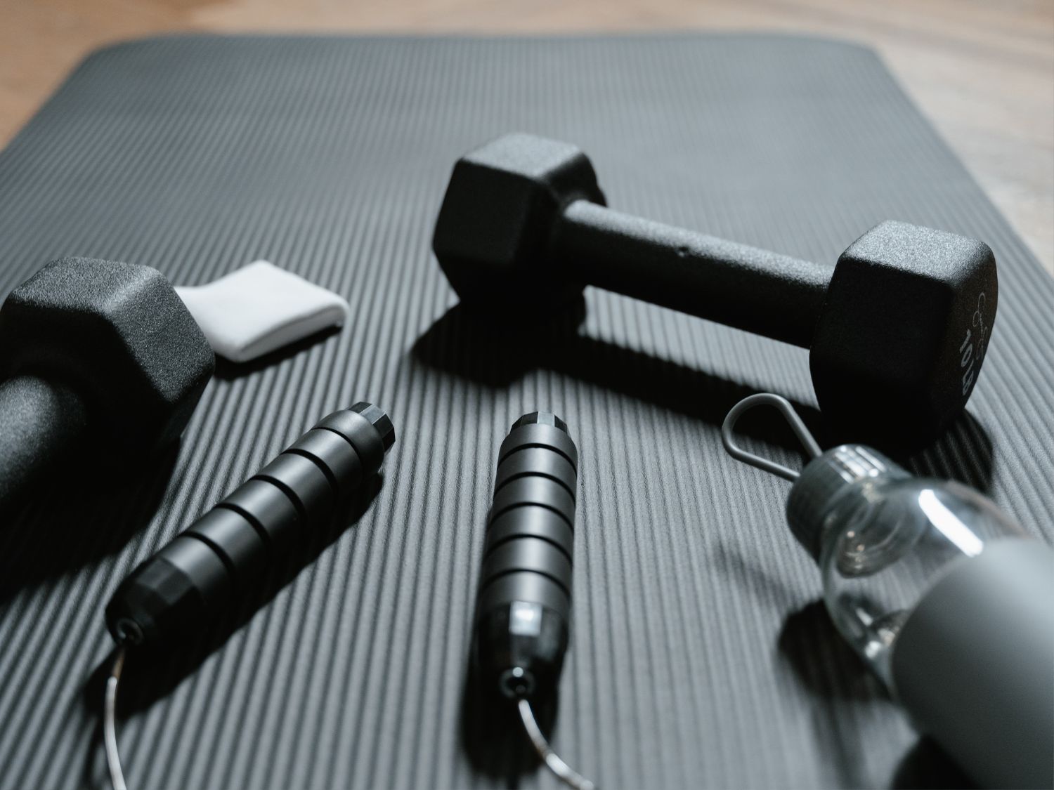 A close up view of a rubber mat in a gym with workout materials
